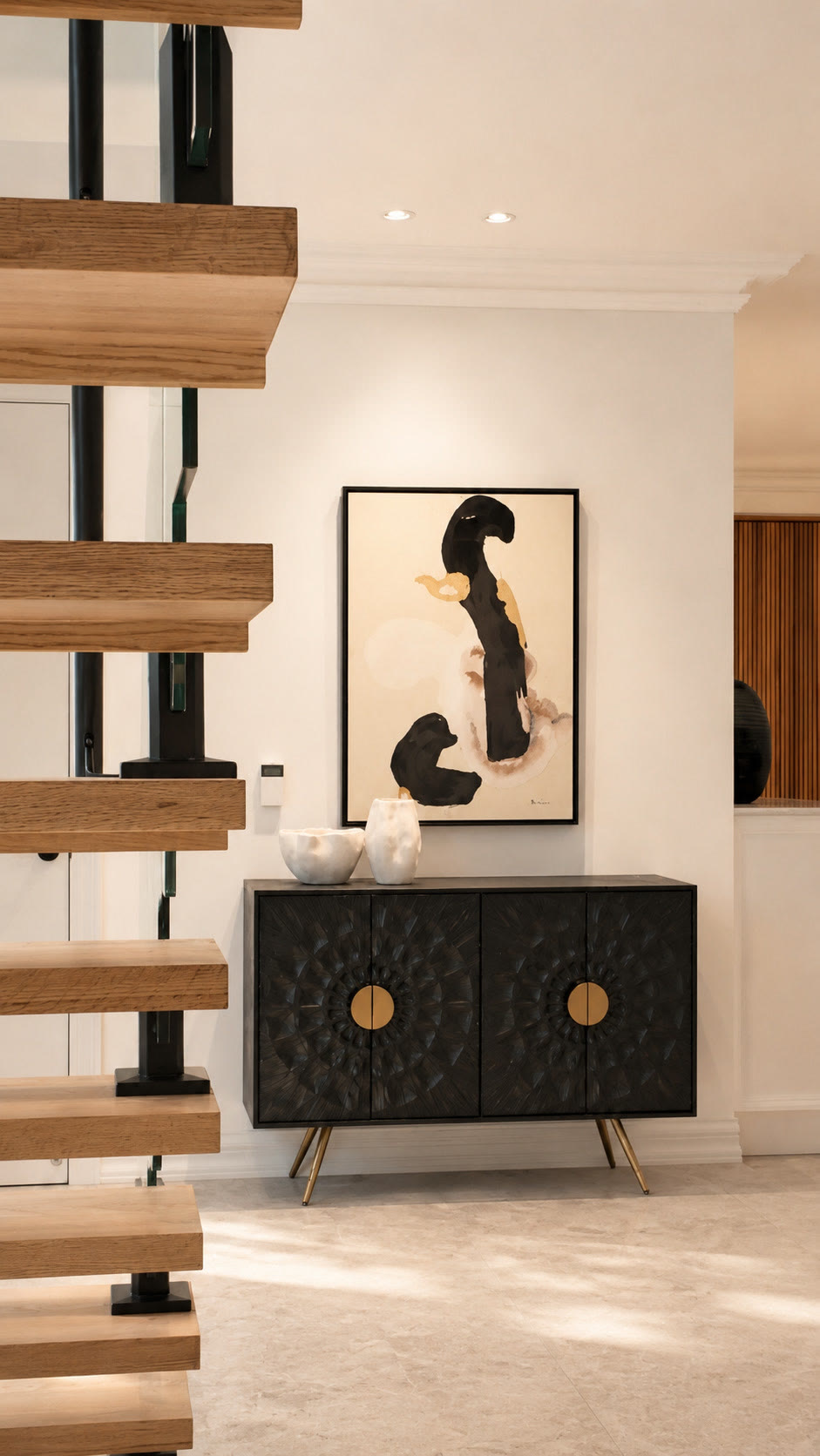 Black carved sideboard and abstract painting beside a floating timber staircase