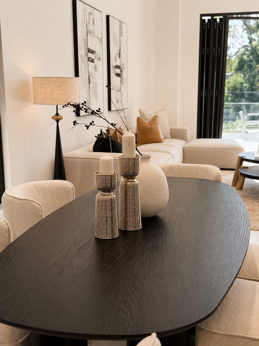Black oval dining table with sculptural vases
