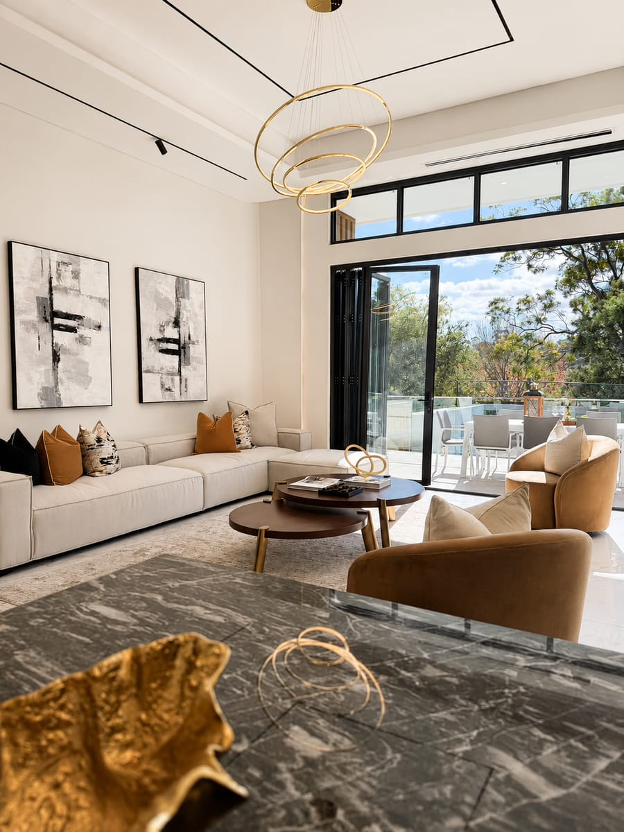 Living area seen past a marble kitchen island to the terrace